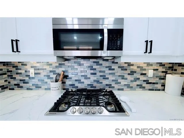 2476 Fallbrook Place Escondido, CA 92027 - Photo 15 of 33 a kitchen with a stove a sink and a microwave
