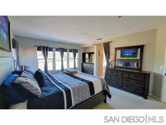 2476 Fallbrook Place Escondido, CA 92027 - Photo 16 of 33 a living room with a bed furniture and a flat screen tv