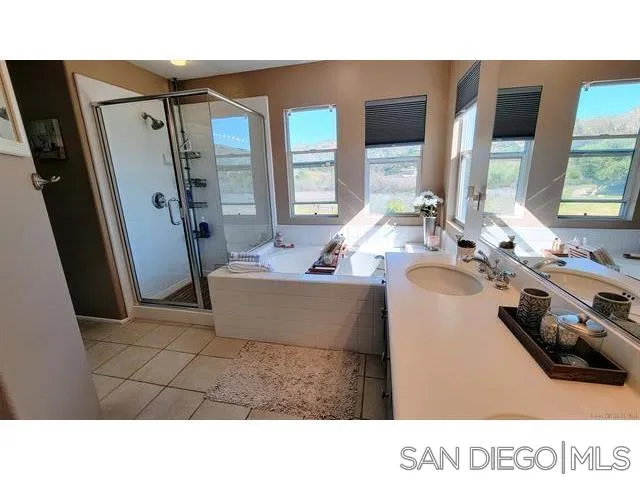 2476 Fallbrook Place Escondido, CA 92027 - Photo 20 of 33 a bathroom with a tub sink and mirror