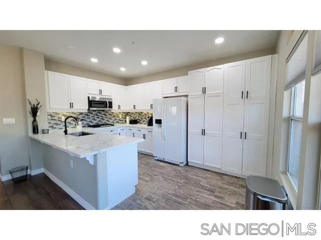 2476 Fallbrook Place Escondido, CA 92027 - Photo 9 of 33 a kitchen with kitchen island cabinets and refrigerator