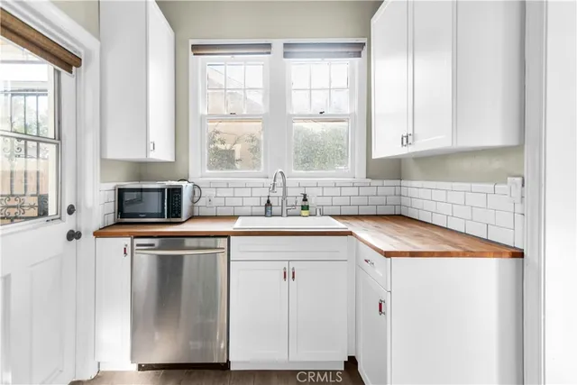 a kitchen with stainless steel appliances granite countertop a sink and a stove