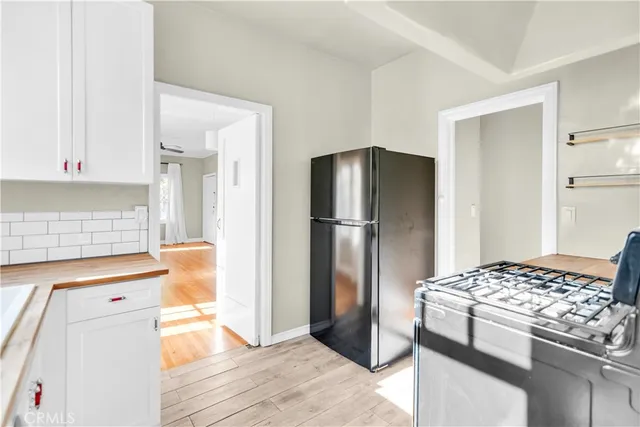 a kitchen with stainless steel appliances granite countertop a refrigerator and a stove