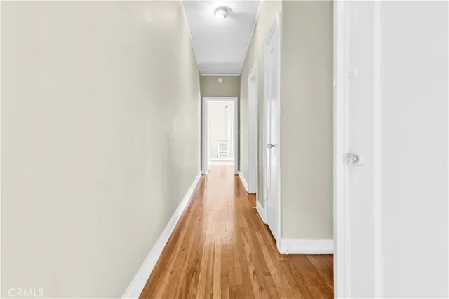 a view of a hallway with wooden floor
