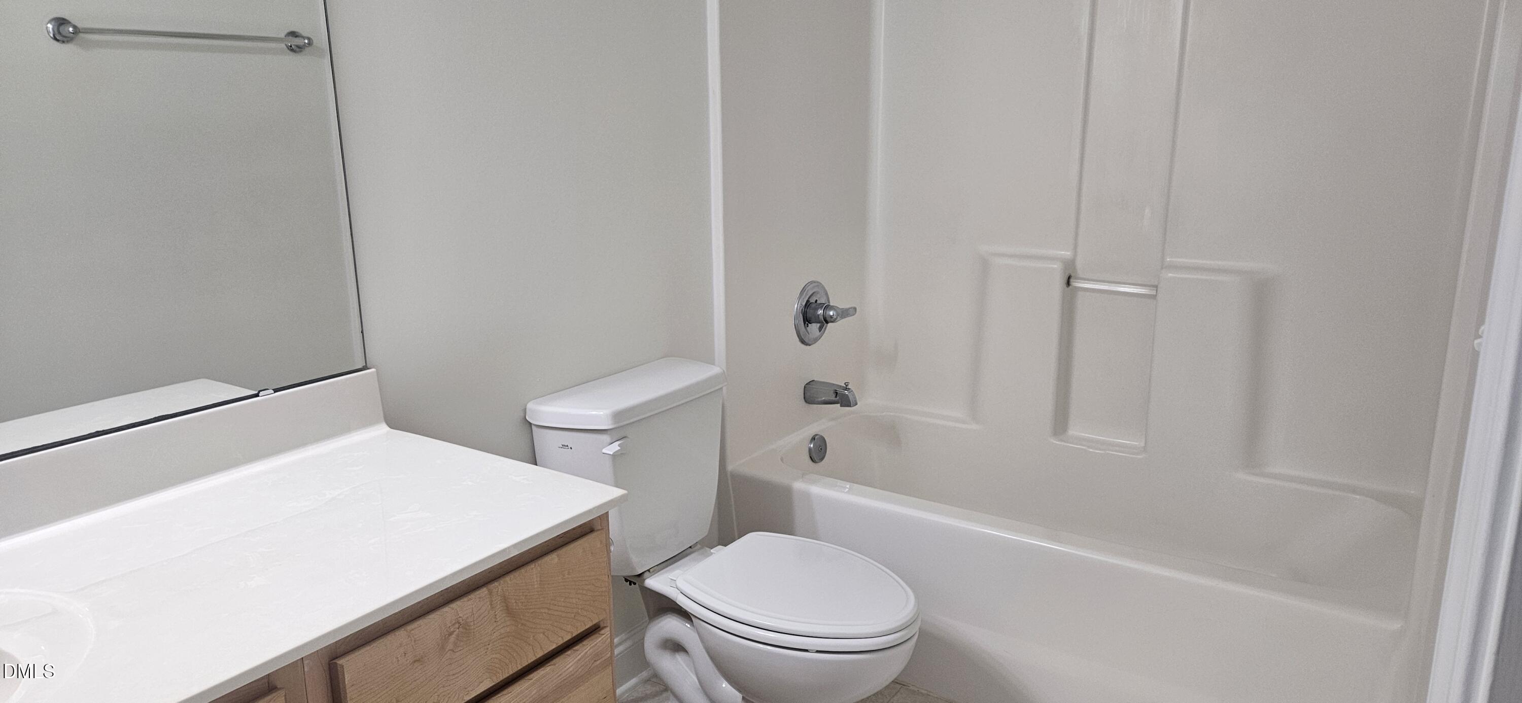 138 West Savannah Ridge Road Holly Springs, NC 27540 - Photo 18 of 22 a white toilet sitting next to a bath tub