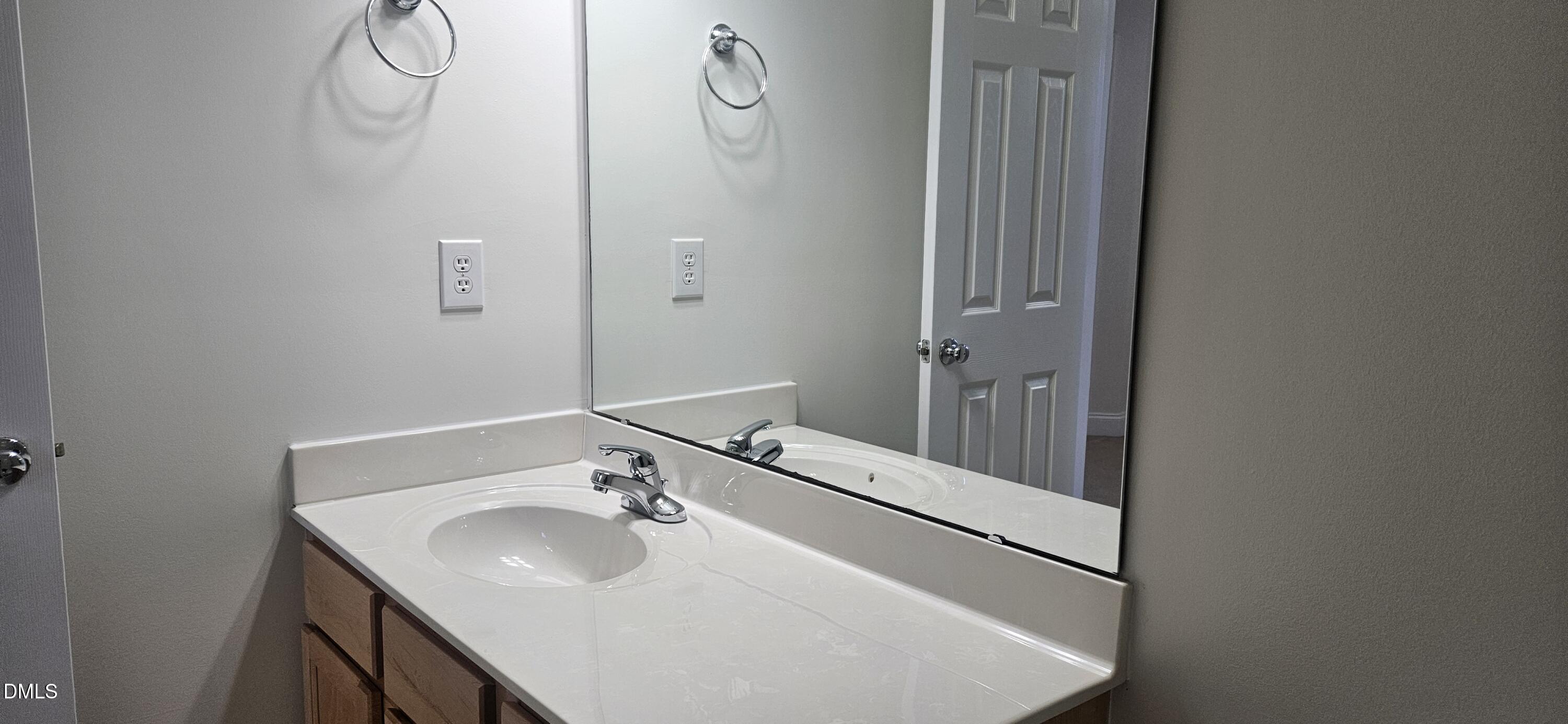 138 West Savannah Ridge Road Holly Springs, NC 27540 - Photo 19 of 22 a bathroom with a sink and a mirror