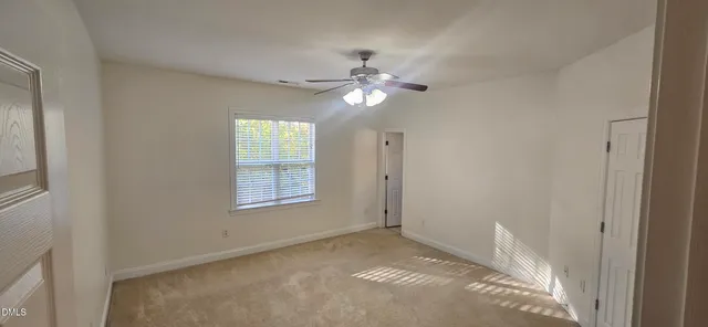 a view of an empty room with a fan