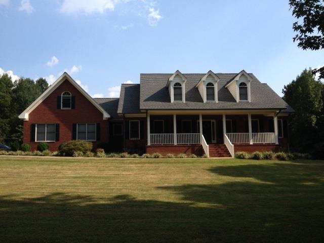 800 Seabolt Road Locust Grove, GA 30248 - Photo 1 of 1 a front view of a house with a garden