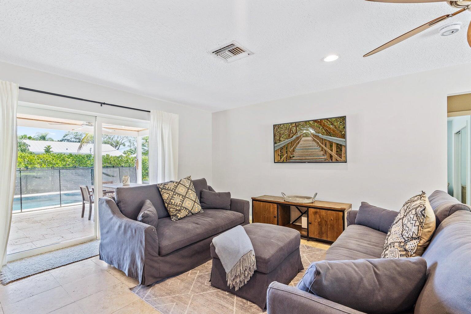 356 Mars Avenue Tequesta, FL 33469 - Photo 16 of 26 a living room with furniture and a large window