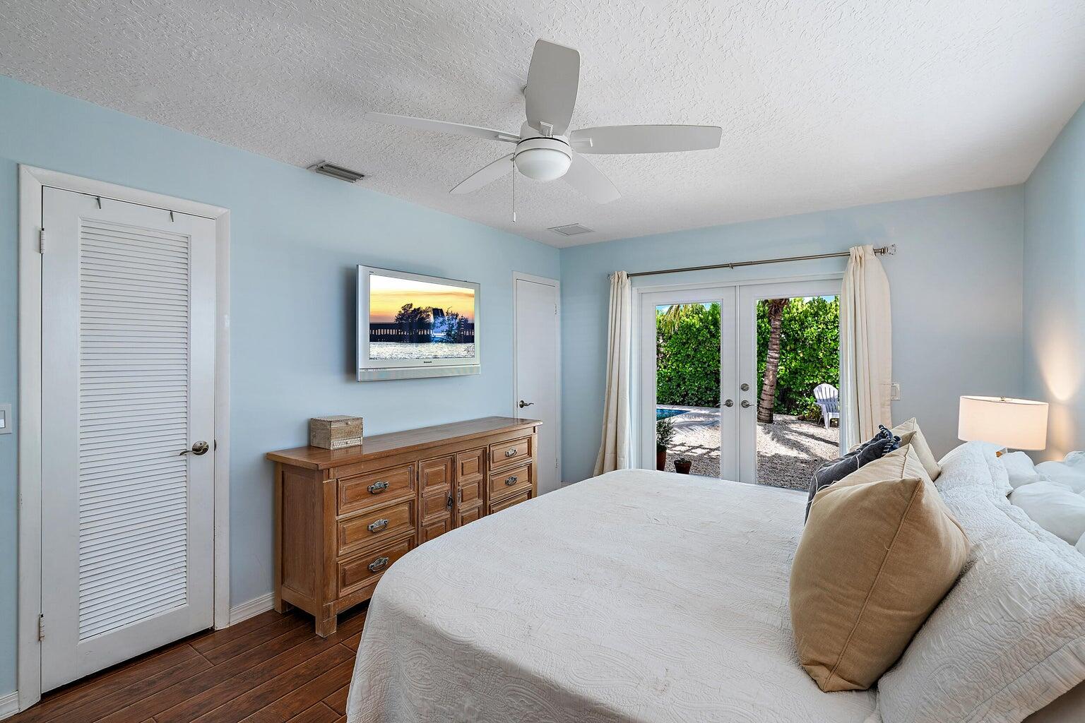 356 Mars Avenue Tequesta, FL 33469 - Photo 19 of 26 a bedroom with a bed and a large window