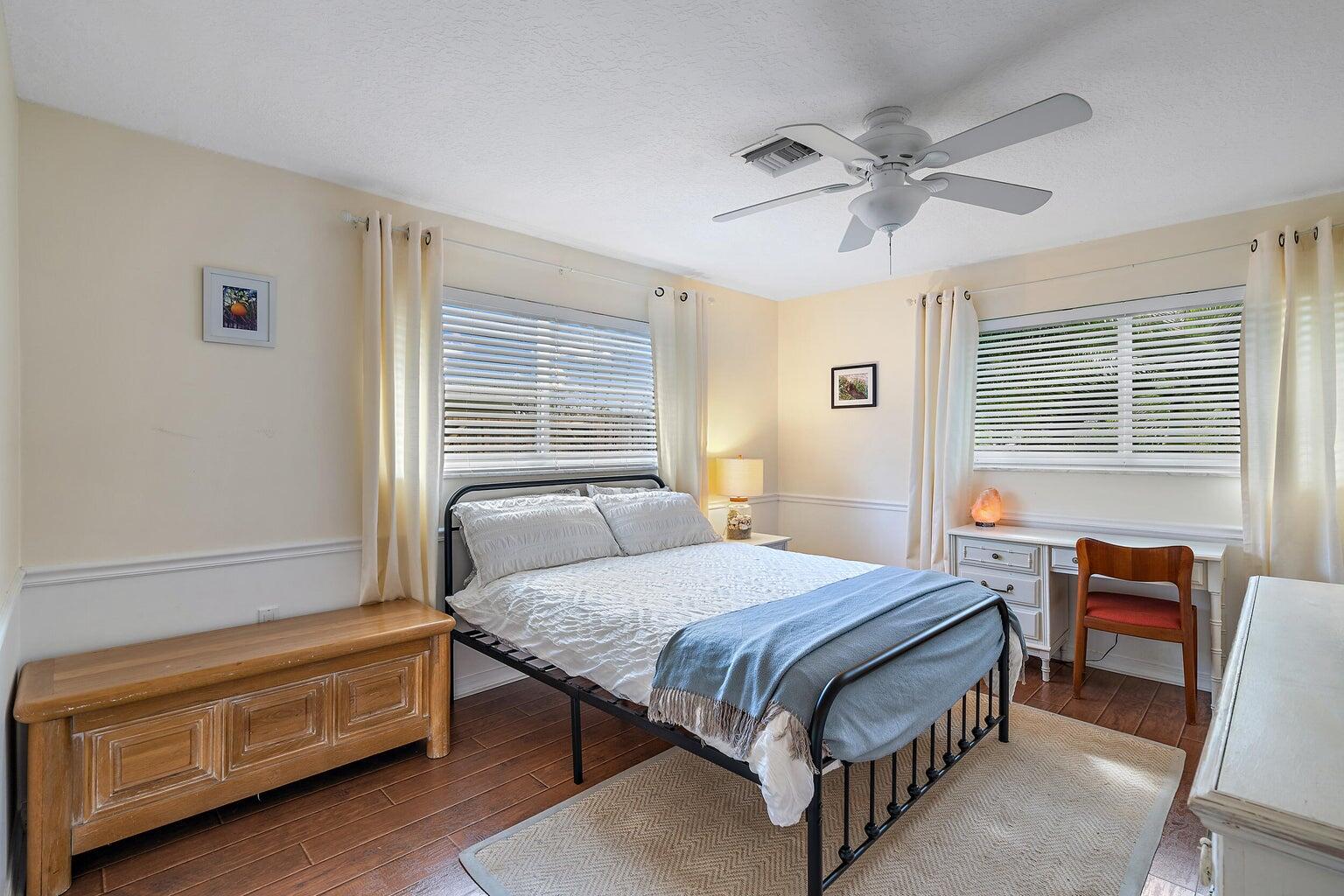 356 Mars Avenue Tequesta, FL 33469 - Photo 21 of 26 a bedroom with a bed and a chandelier