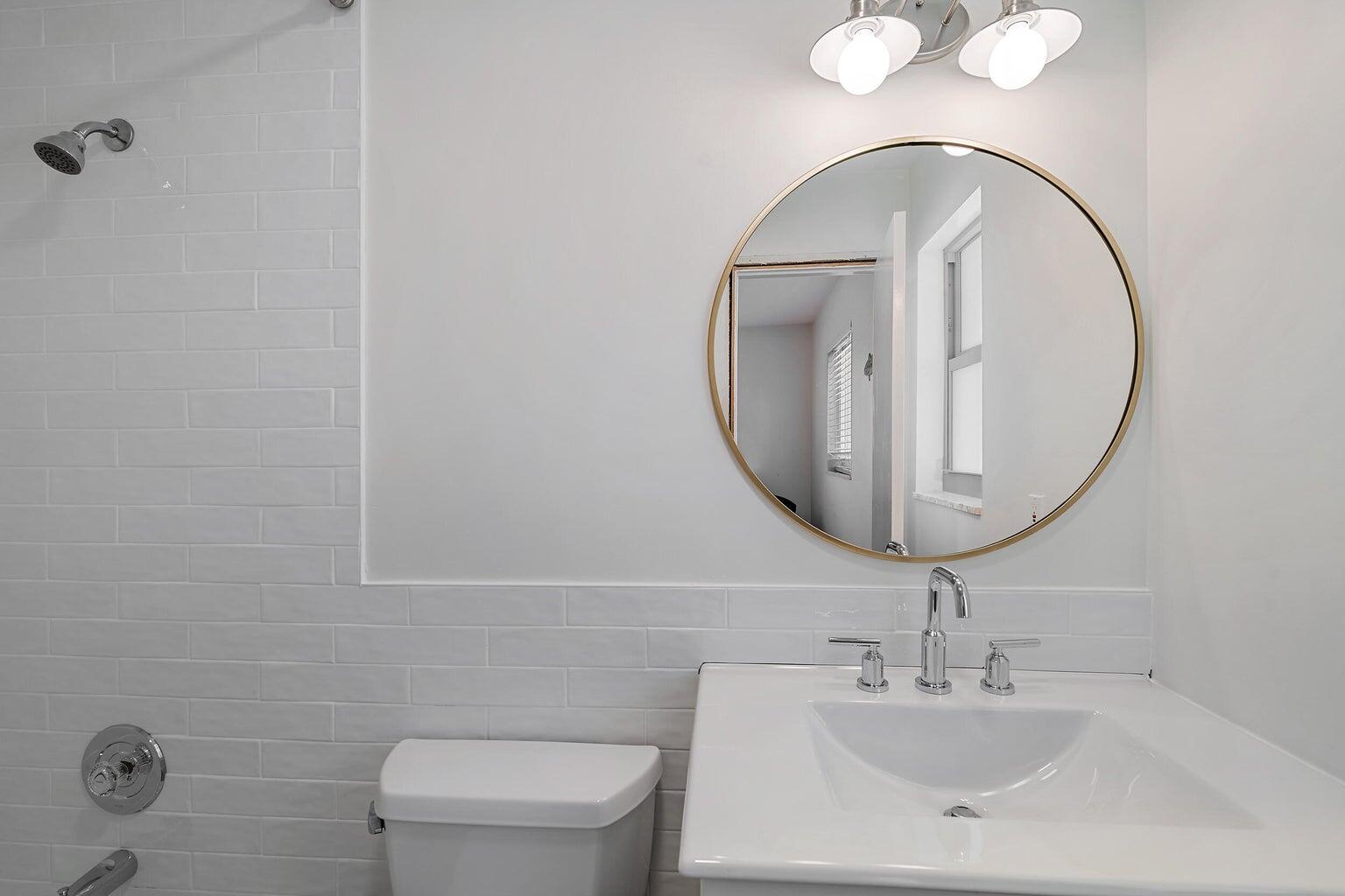 356 Mars Avenue Tequesta, FL 33469 - Photo 23 of 26 a bathroom with a toilet a sink and mirror