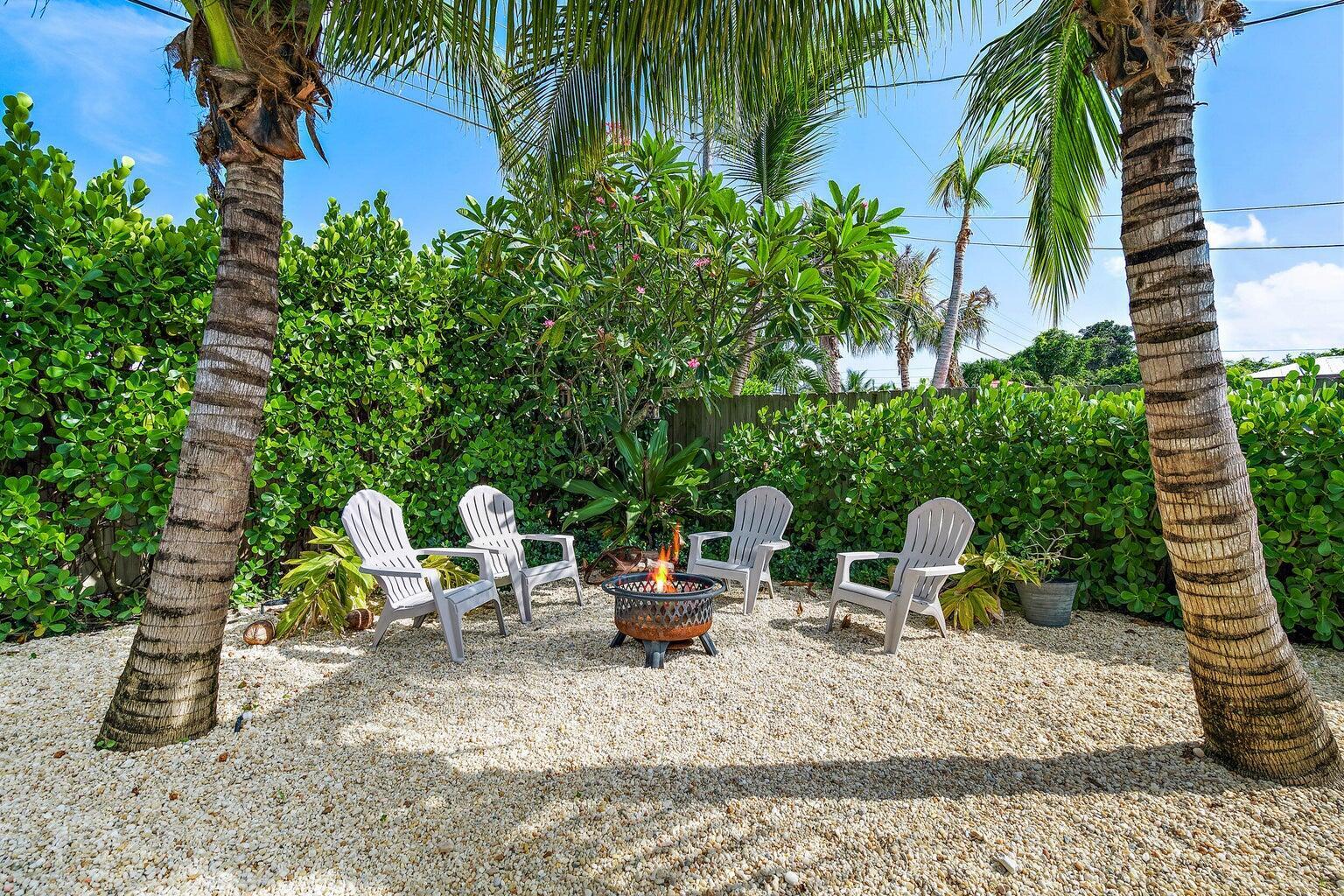 356 Mars Avenue Tequesta, FL 33469 - Photo 4 of 26 a backyard of a house with outdoor seating