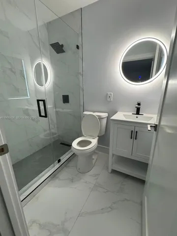 a bathroom with a sink a toilet and a shower