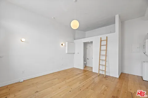 a view of a room with wooden floor and window