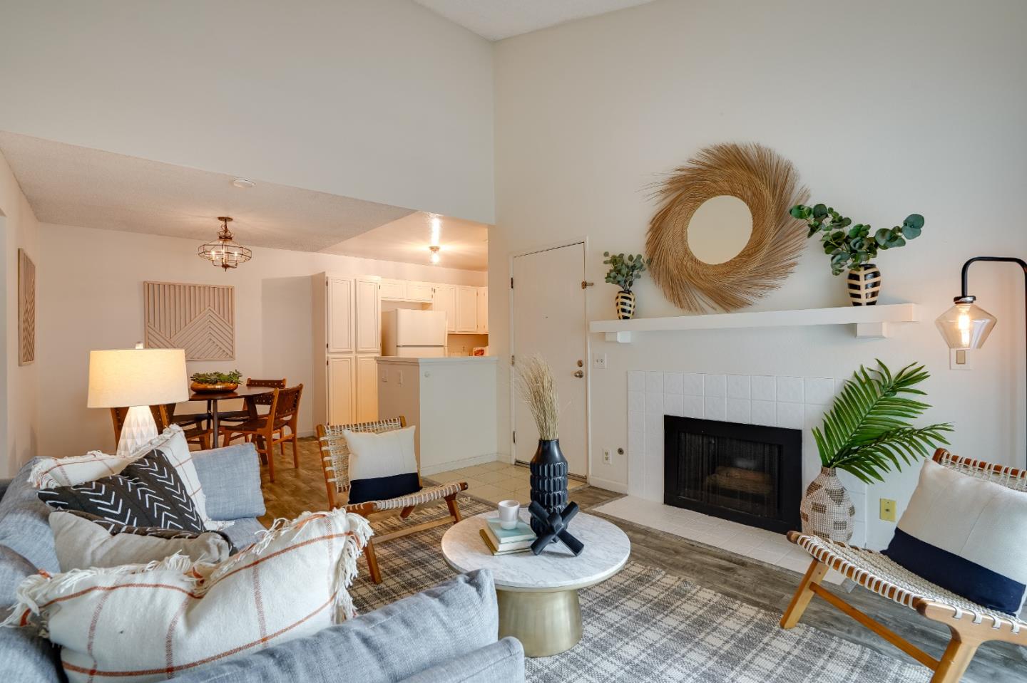 a living room with furniture a fireplace and a potted plant