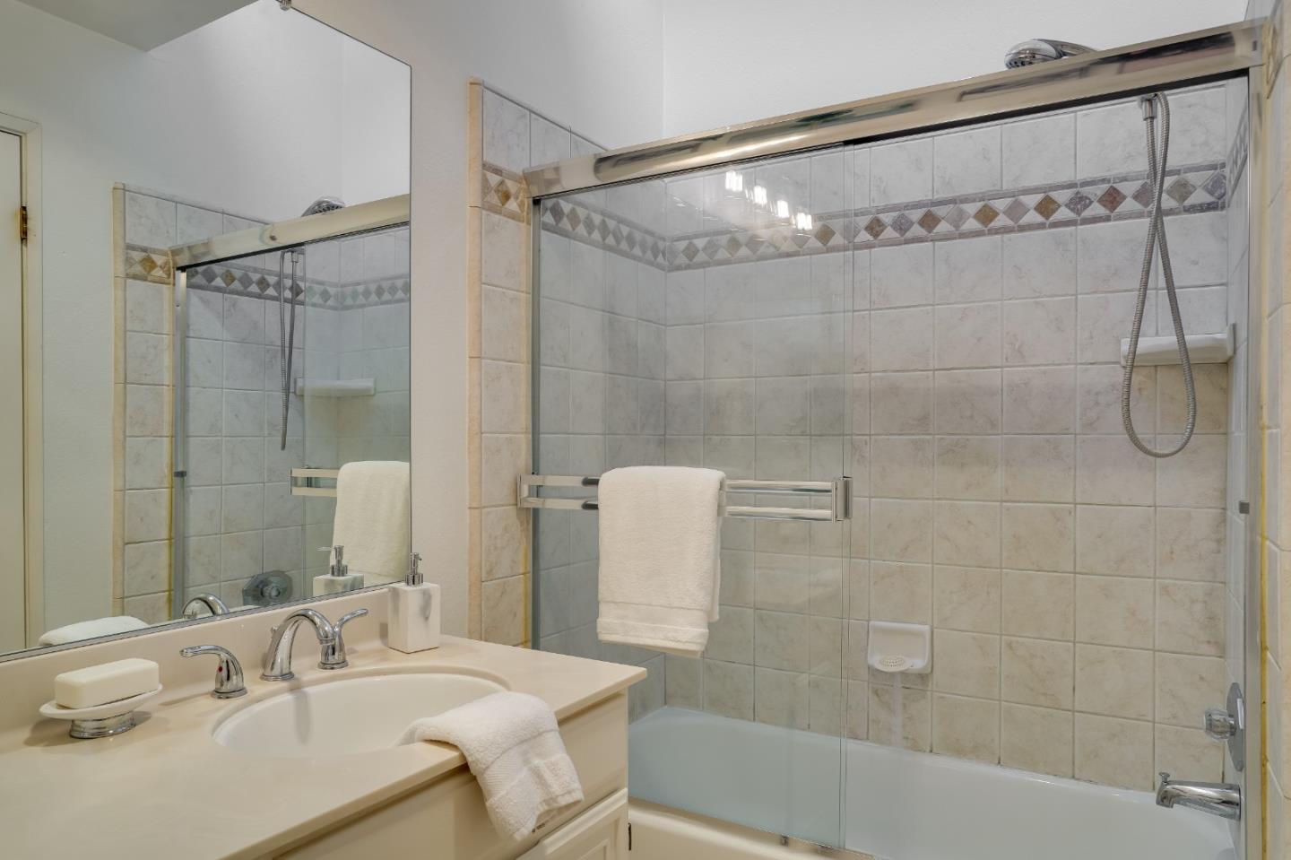 37050 Meadowbrook Common, Unit 302 Fremont, CA 94536 - Photo 17 of 21 a bathroom with a sink shower and a mirror