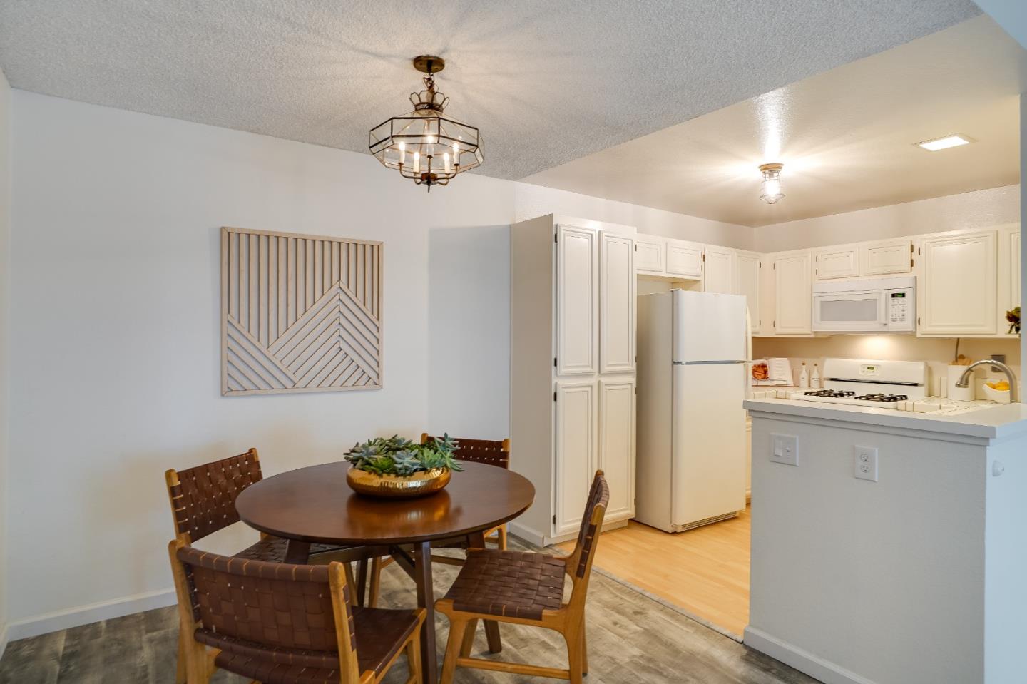 37050 Meadowbrook Common, Unit 302 Fremont, CA 94536 - Photo 9 of 21 a view of a dining room with furniture and wooden floor