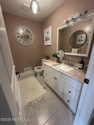 a bathroom with a toilet a sink and a mirror