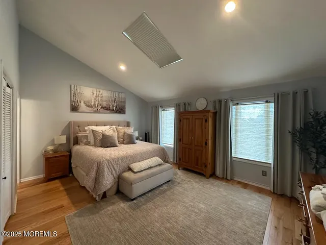 a spacious bedroom with a bed and a television