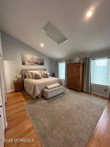 a bedroom with a large bed and a large window