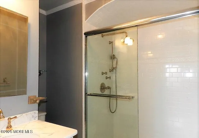 a bathroom with a shower and a sink