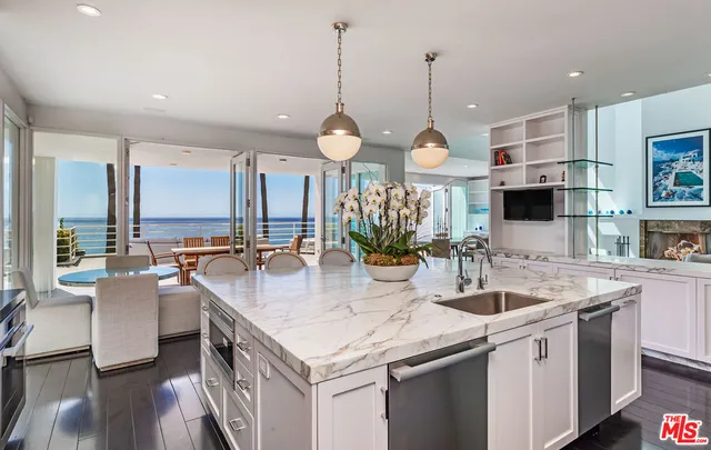 a kitchen with stainless steel appliances granite countertop a sink stove and wooden floor