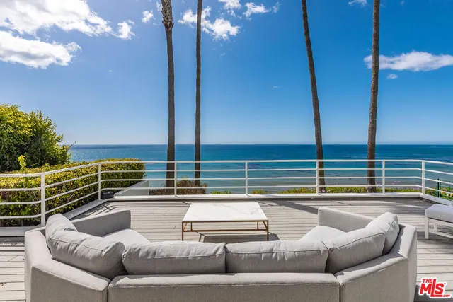 a view of swimming pool with a couches