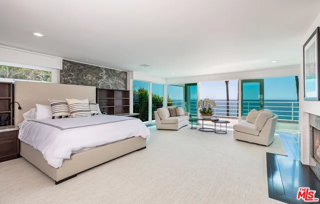 a bedroom with bed and large window