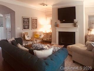 122 Singleton Road Mooresville, NC 28117 - Photo 2 of 8 a living room with furniture a flat screen tv and a fireplace
