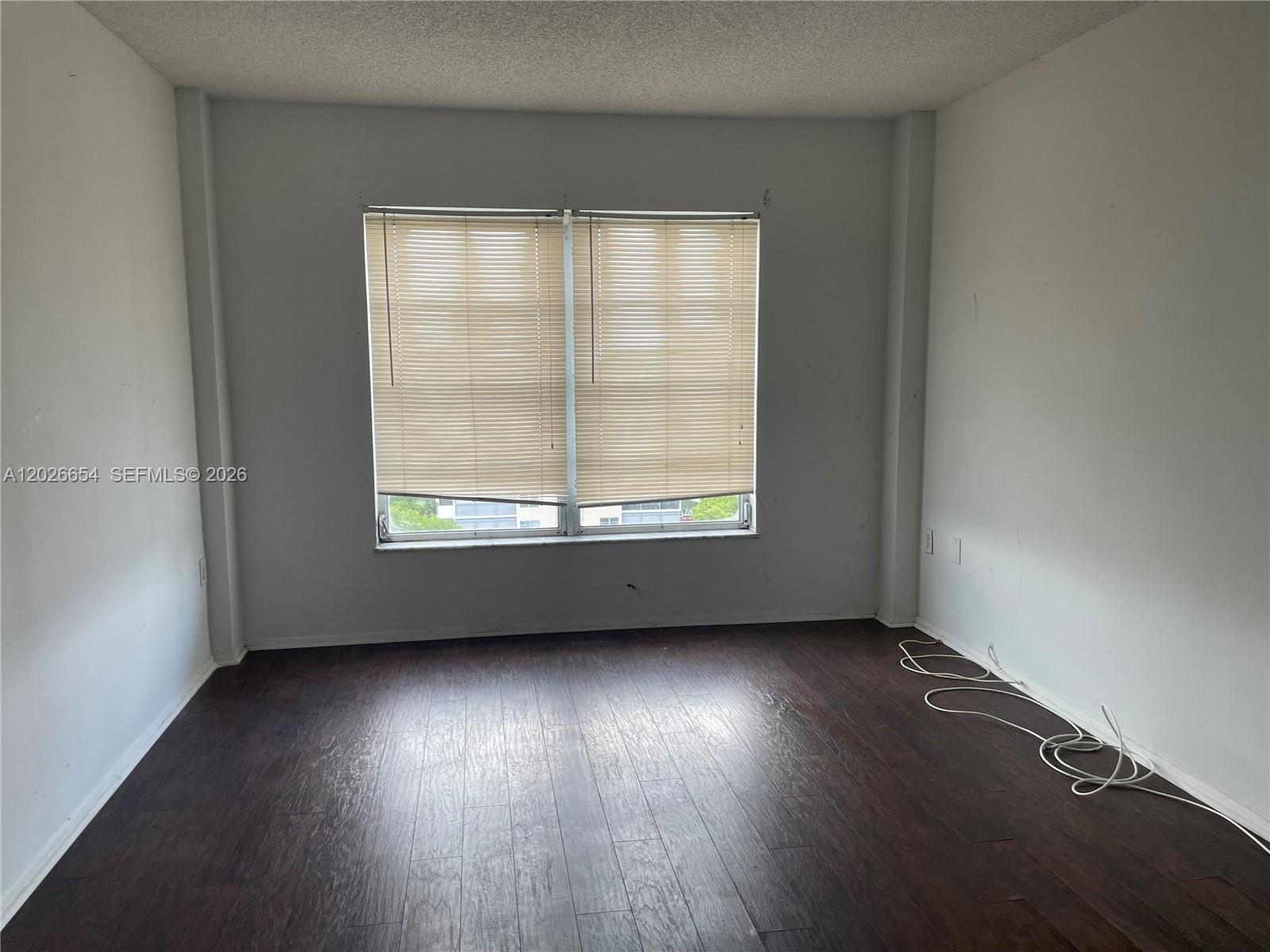 4174 Inverrary Drive, Unit 903 Lauderhill, FL 33319 - Photo 24 of 36 an empty room with wooden floor and windows
