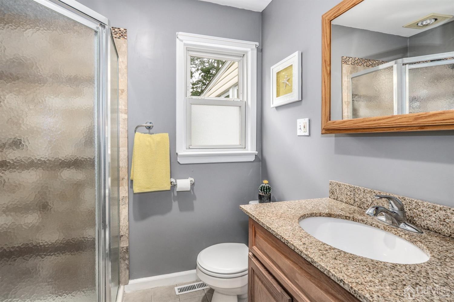 217 Oxford Road Edison, NJ 08820 - Photo 12 of 27 a bathroom with a granite countertop sink toilet and shower