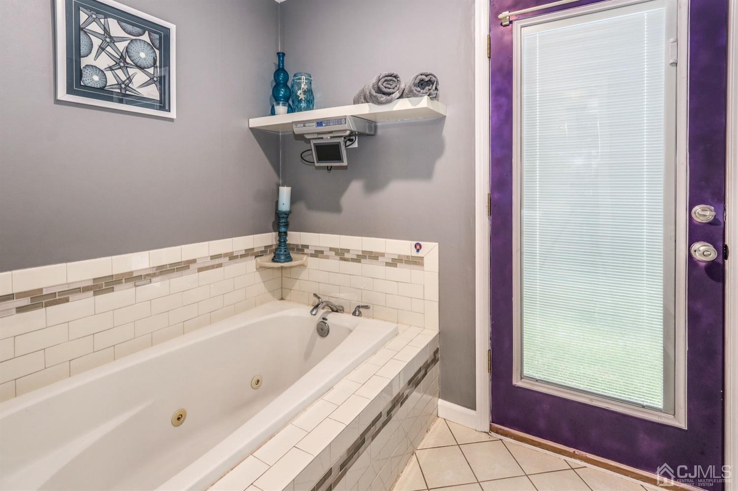 217 Oxford Road Edison, NJ 08820 - Photo 17 of 27 a bathroom with a tub and a window