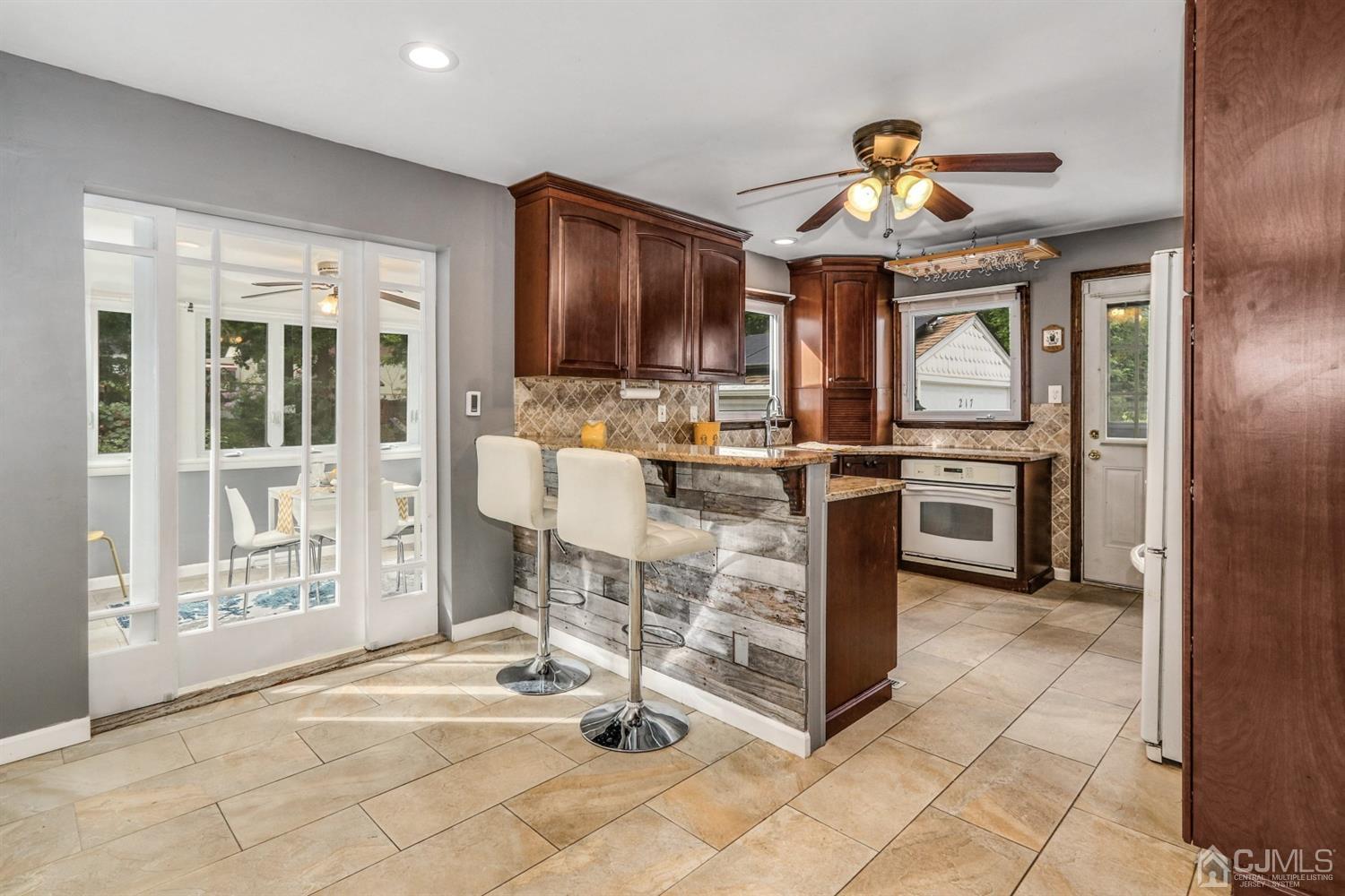 217 Oxford Road Edison, NJ 08820 - Photo 7 of 27 a view of a room with chairs and chandelier