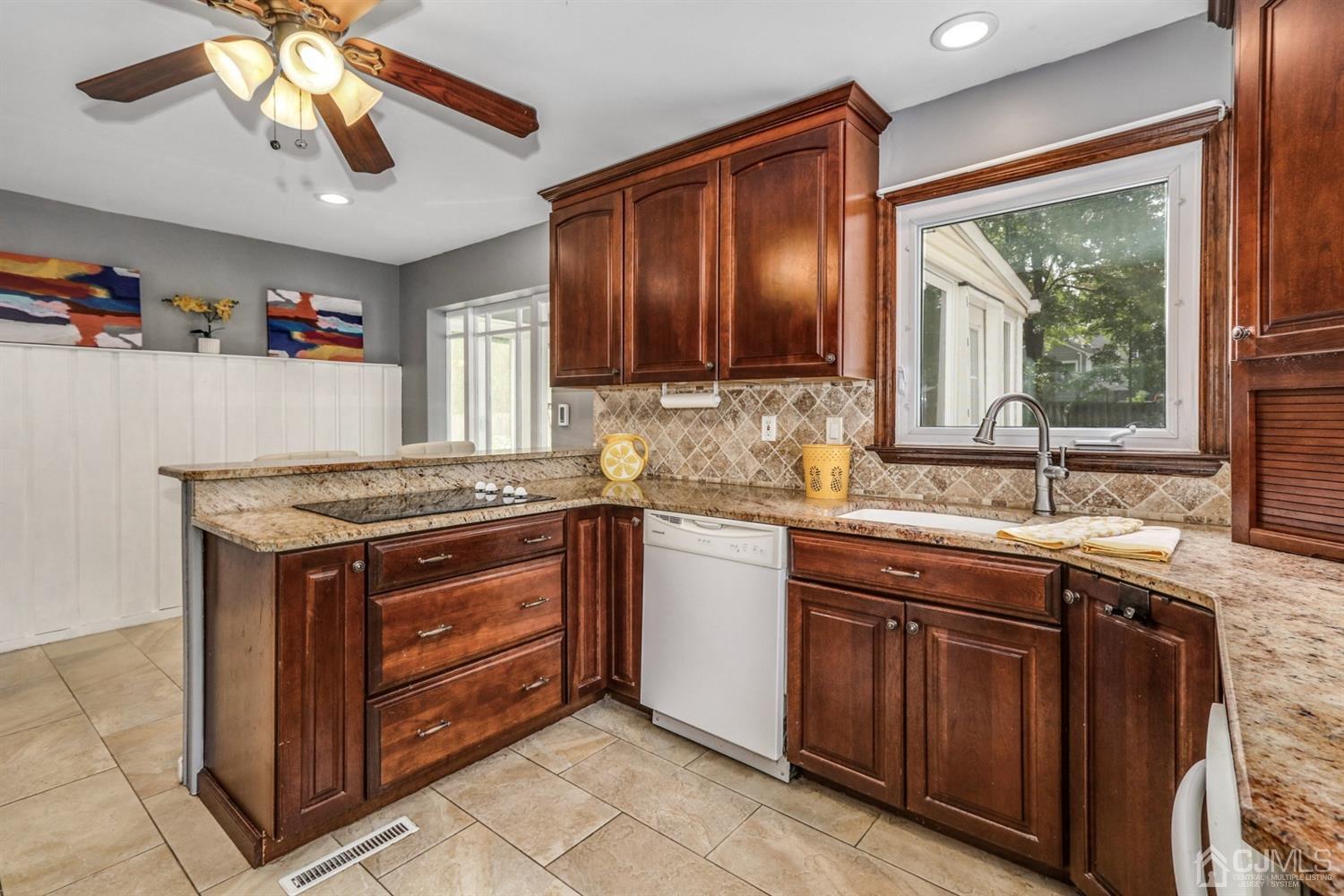 217 Oxford Road Edison, NJ 08820 - Photo 9 of 27 a kitchen with a stove sink and cabinets