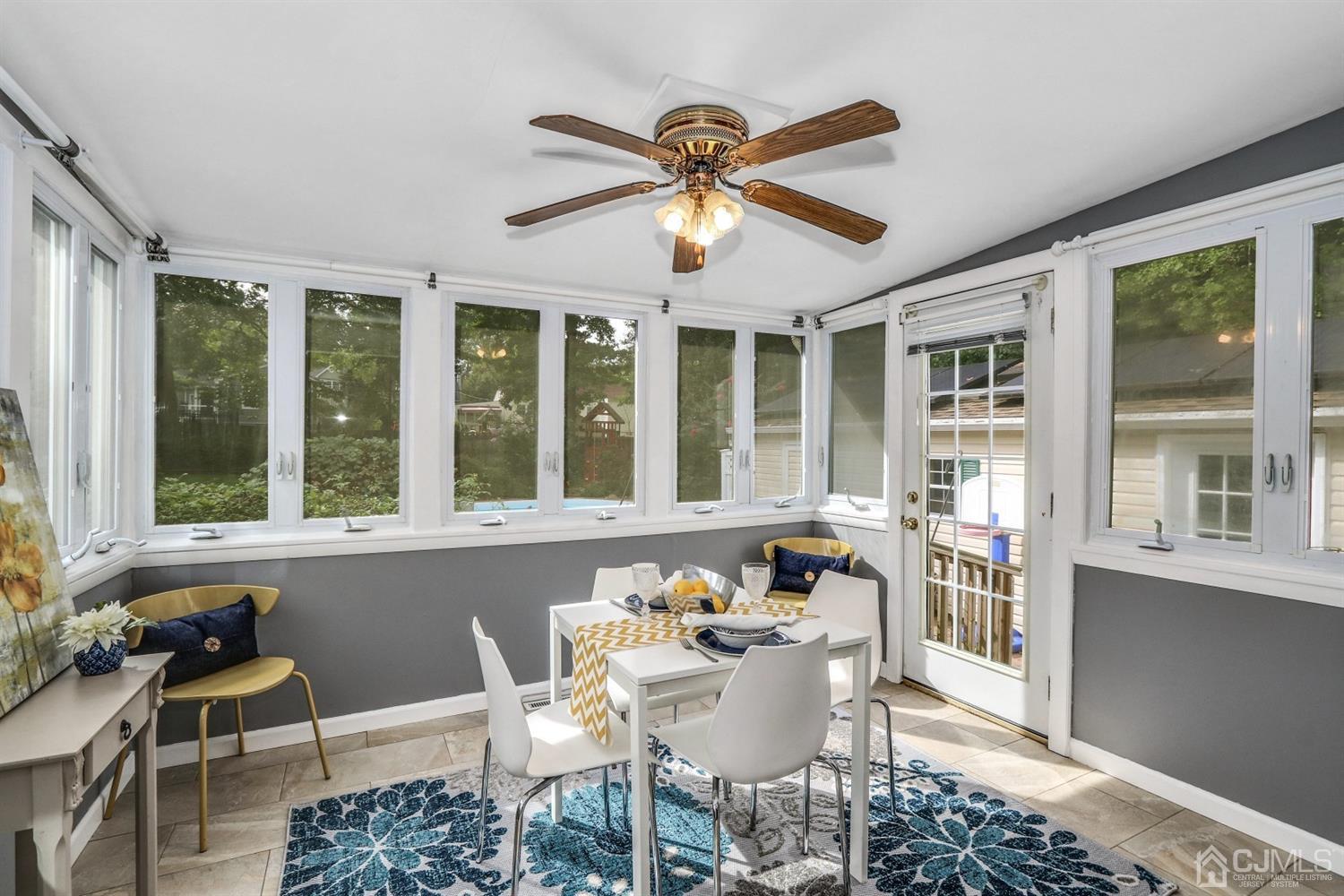 217 Oxford Road Edison, NJ 08820 - Photo 10 of 27 a dining room with furniture a chandelier and a rug
