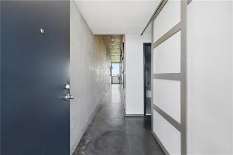 a view of a hallway with wooden floor and closet