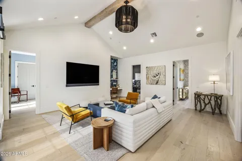 a bedroom with a bed and a painting on the wall