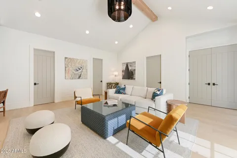 a living room with furniture a flat screen tv and a large window