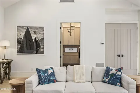 a bedroom with a large bed and a flat screen tv