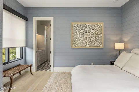 a view of a patio with table and chairs potted plants and floor to ceiling window