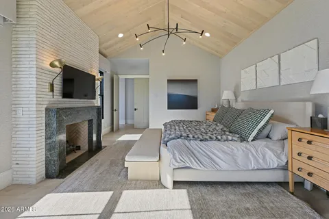 a view of an empty room with a fireplace and a window