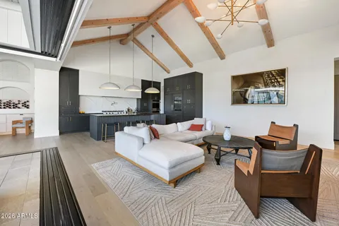 a living room with furniture and a chandelier