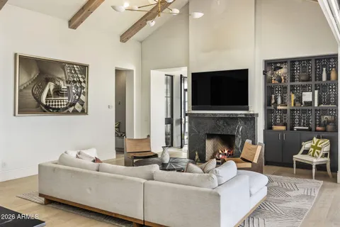 a living room with stainless steel appliances kitchen island granite countertop furniture and a view of kitchen