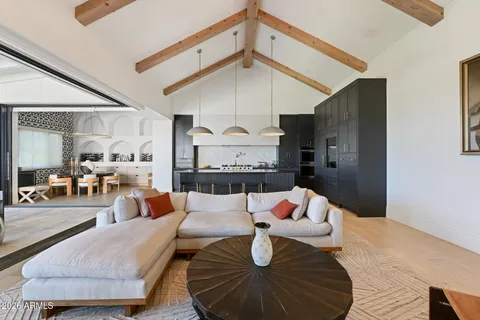 a kitchen with granite countertop a stove a sink and a refrigerator