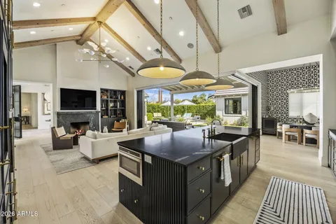 a kitchen with stainless steel appliances granite countertop a stove a sink and a refrigerator