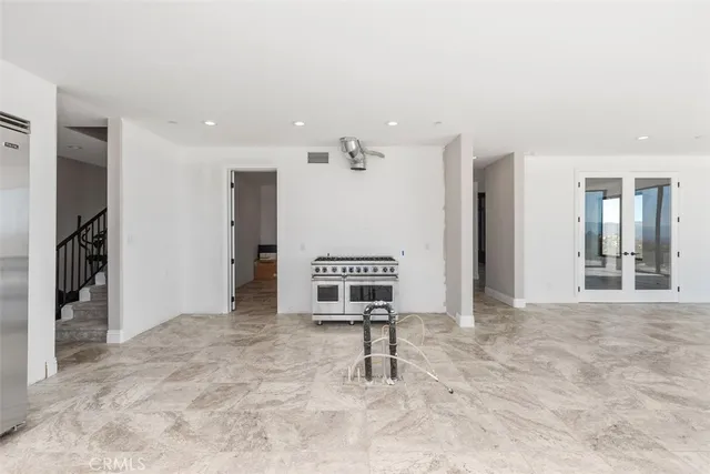 a kitchen with a stove a sink a microwave a dining table and chairs