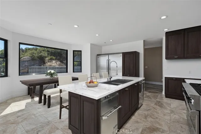 a view of an empty room with a fireplace and a ceiling fan