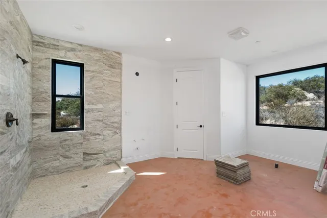 a view of an empty room with a sliding door and city view