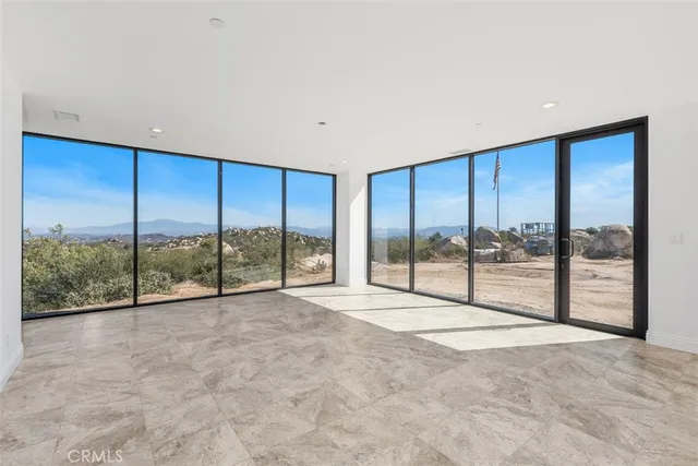 an empty room with painting on the wall