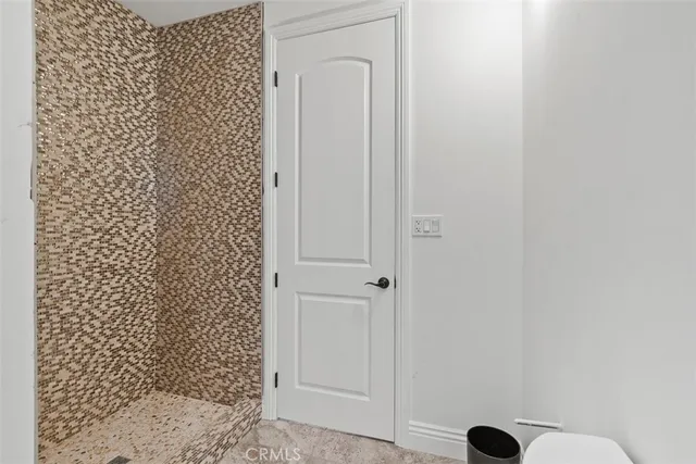 a bedroom with furniture and a large window